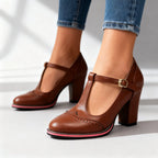 Pair of brown T-strap brogue heels with pink contrast sole and block heel in studio light