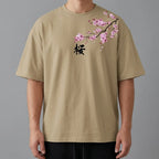 Close-up front view of khaki tee showing the cherry blossom branch print, kanji character and sleeve placement