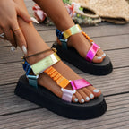 Front angle of black colour-blocked platform sandals with ruched centre strap and white pedicure