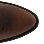 Close-up of the brown leather pointed toe with decorative stitched detailing and sole edge