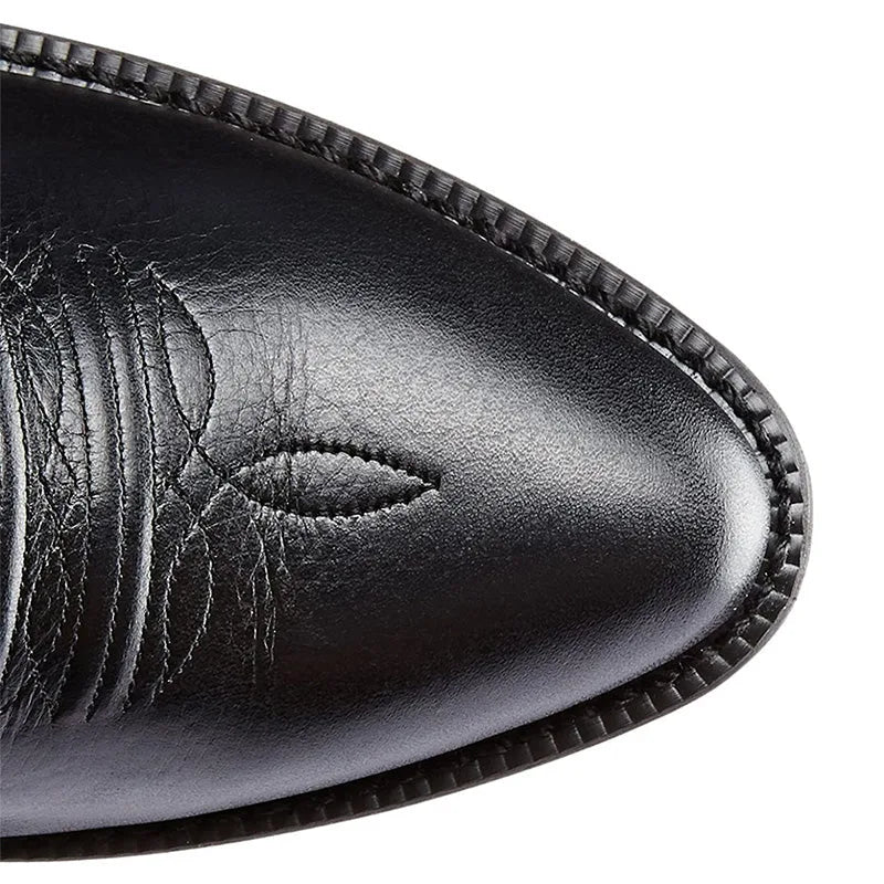 Close-up side view of the black leather boot showing grain texture and tonal western embroidery