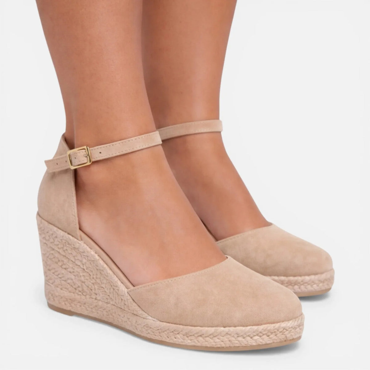 Close side view of beige suede espadrille wedge with buckle fastening and braided jute sole