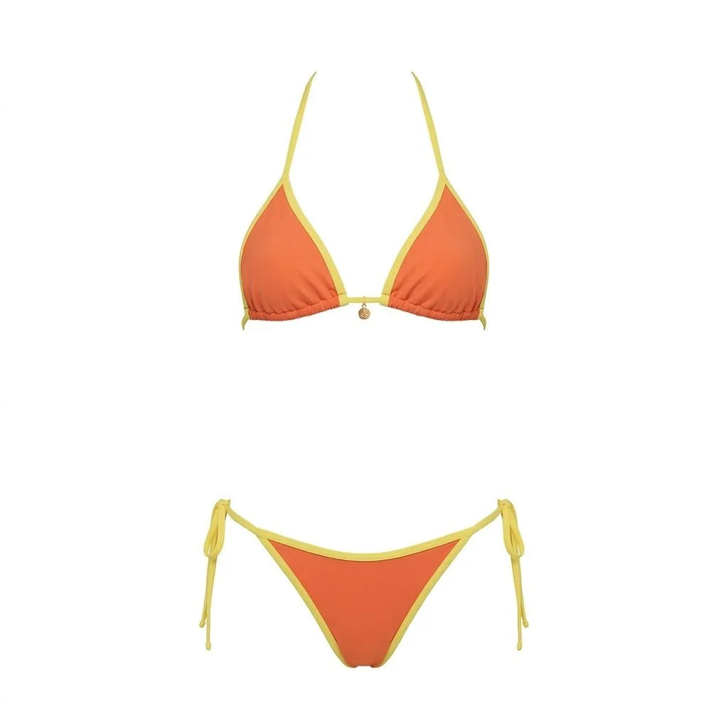 Flat lay detail of navy bikini top showing adjustable slider and gold charm at the centre