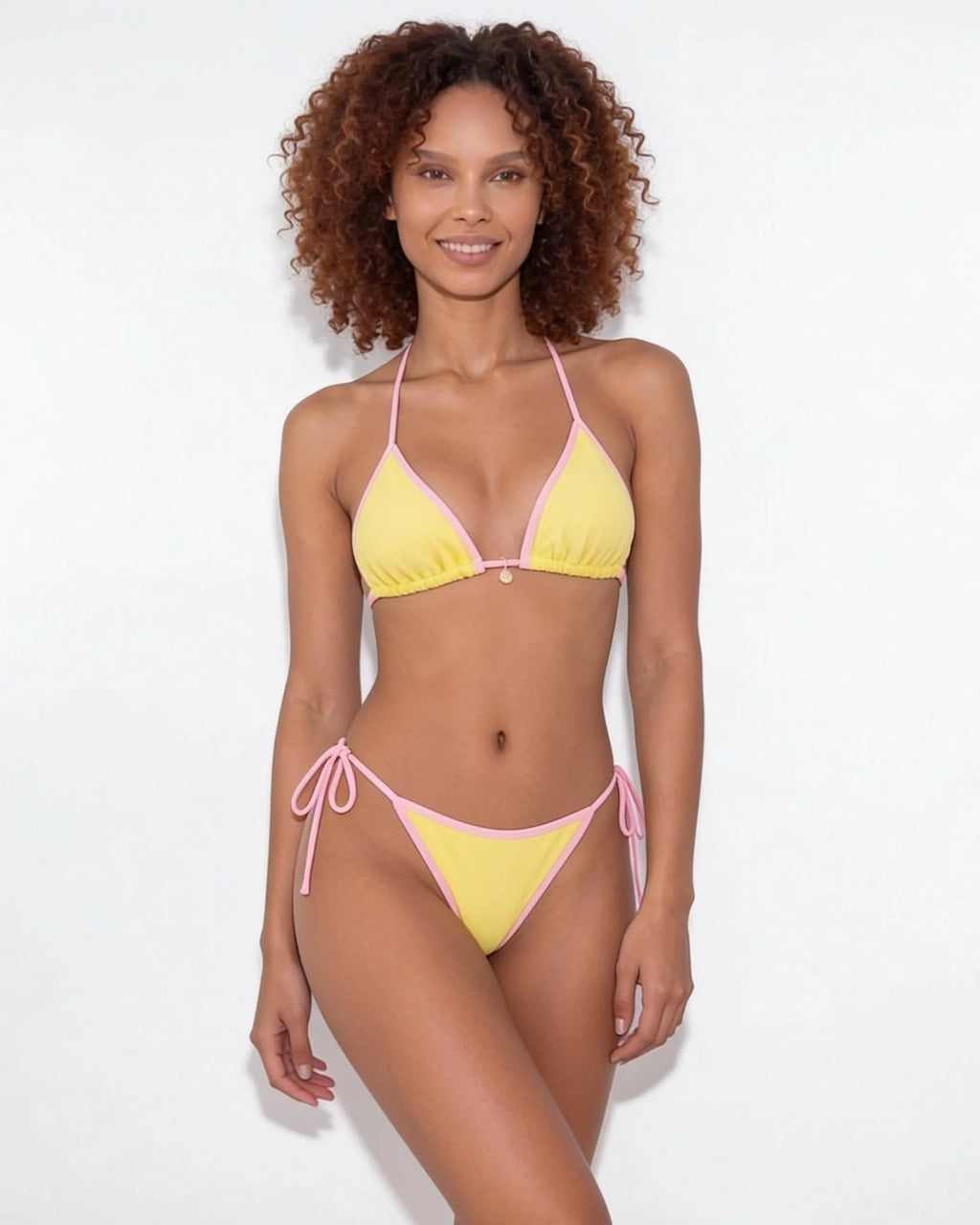 Close-up of brown bikini top strap and cream binding detail at the shoulder
