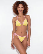 Close-up of brown bikini top strap and cream binding detail at the shoulder