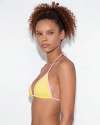 Side view of model in brown triangle bikini showing the high-cut bottom silhouette