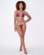 Close-up of navy bikini bottom front showing the triangle shape and cream edging