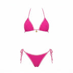 Model wearing navy bikini bottoms showing the adjustable tie-side bow detail