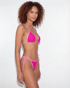 Model in navy bikini standing with arms relaxed, showing the overall silhouette