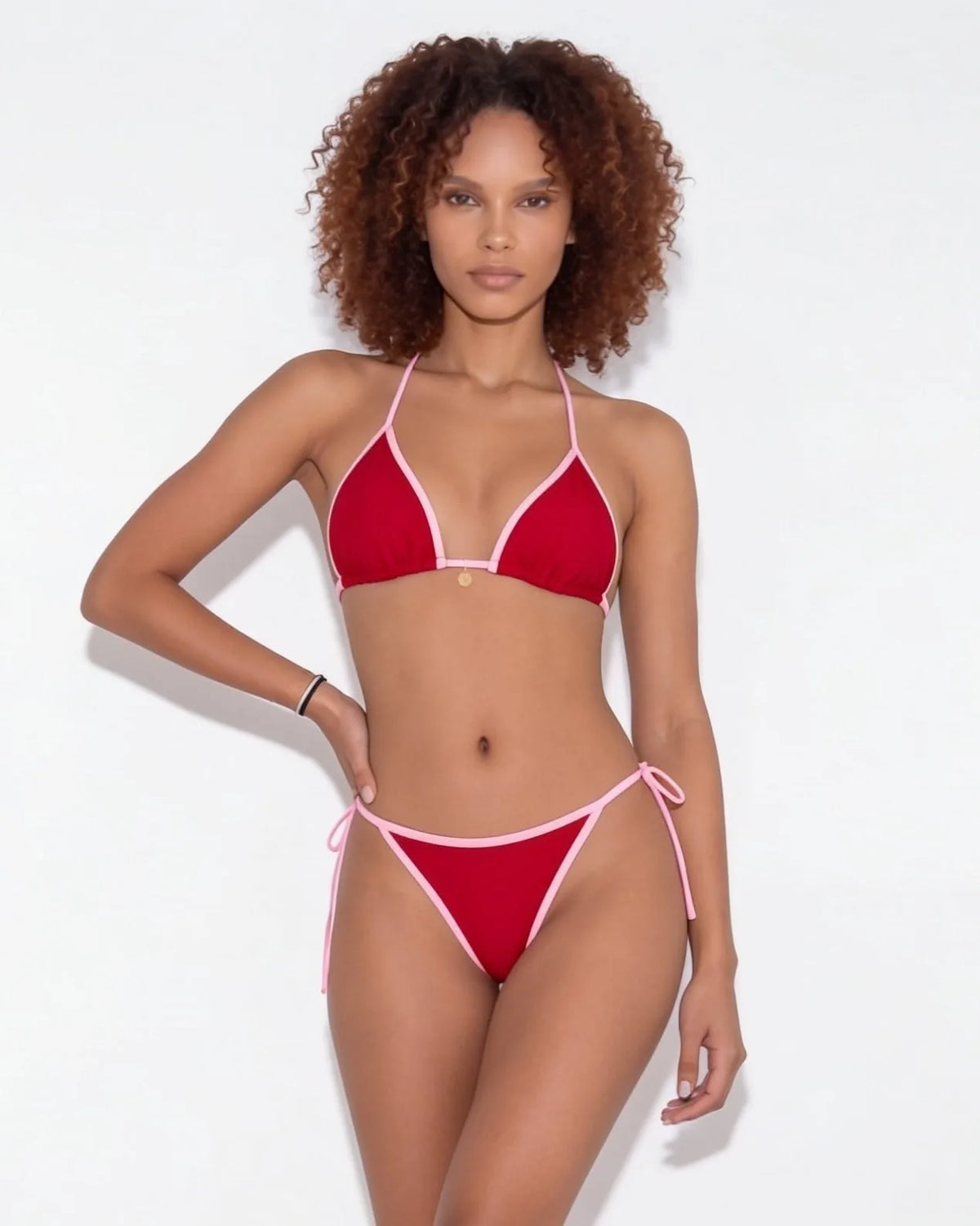 Close-up of navy bikini bottom side tie showing the cord and knot detail