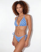 Close-up of shoulder strap and cream piping on the navy triangle bikini top