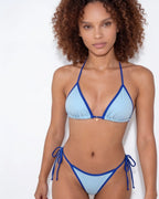 Flat lay close-up of brown bikini bottoms showing the cream tie strings