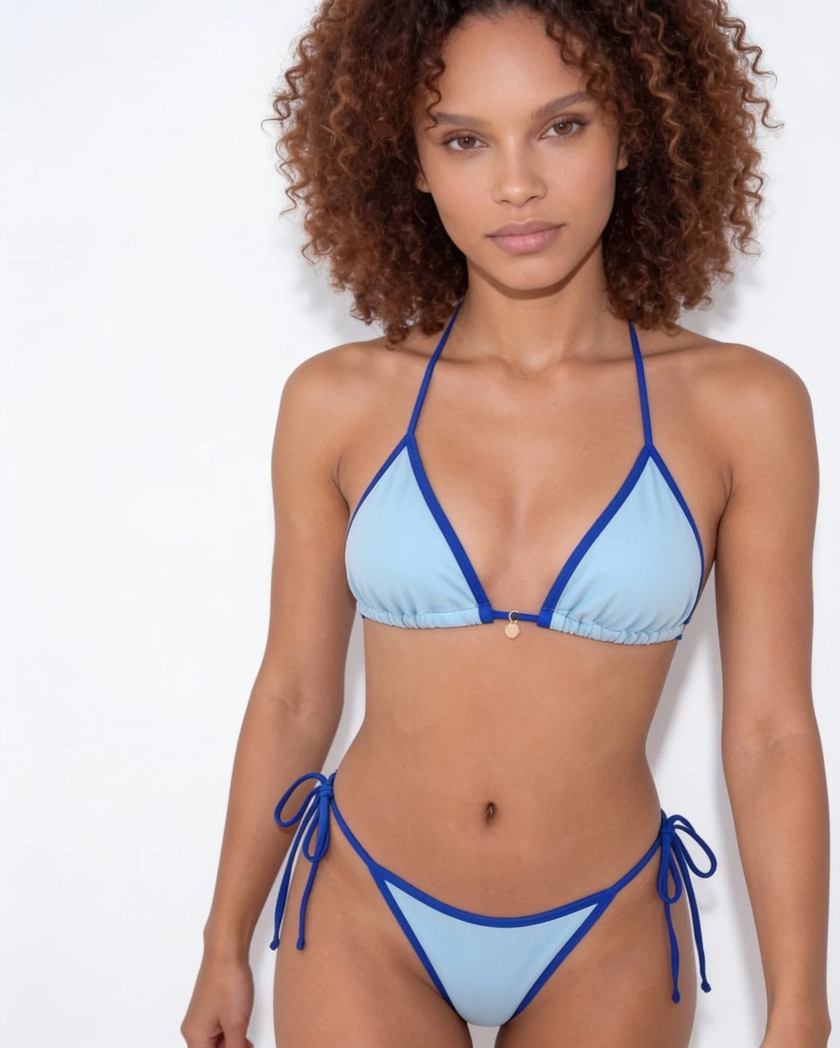 Flat lay close-up of brown bikini bottoms showing the cream tie strings