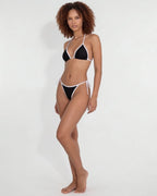 Full-length view of model wearing brown triangle bikini against plain backdrop