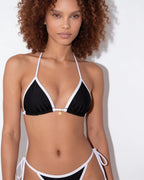 Close-up of brown bikini top straps crossing at the back of the neck