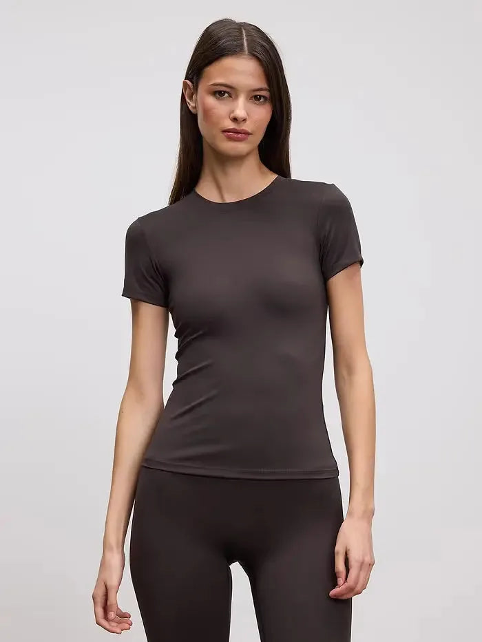 Close-up front view of a fitted dark brown crew neck tee paired with matching brown leggings