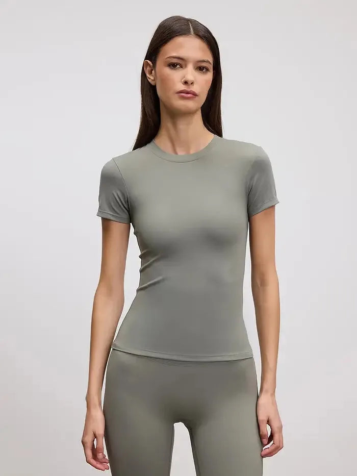 Fitted sage green crew neck tee shown on model with matching sage green leggings