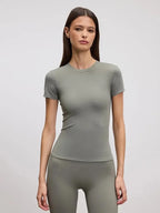 Fitted sage green crew neck tee shown on model with matching sage green leggings