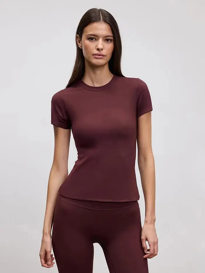 Fitted burgundy crew neck tee shown with matching burgundy leggings against a plain backdrop