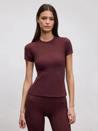 Fitted burgundy crew neck tee shown with matching burgundy leggings against a plain backdrop