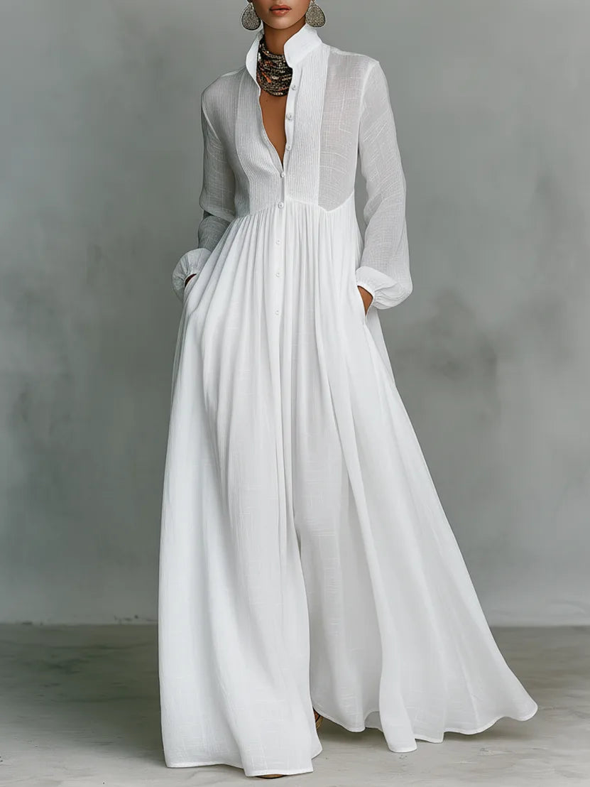 Front view of a model in a white maxi shirt dress with high collar, pintuck bib panel and long sleeves