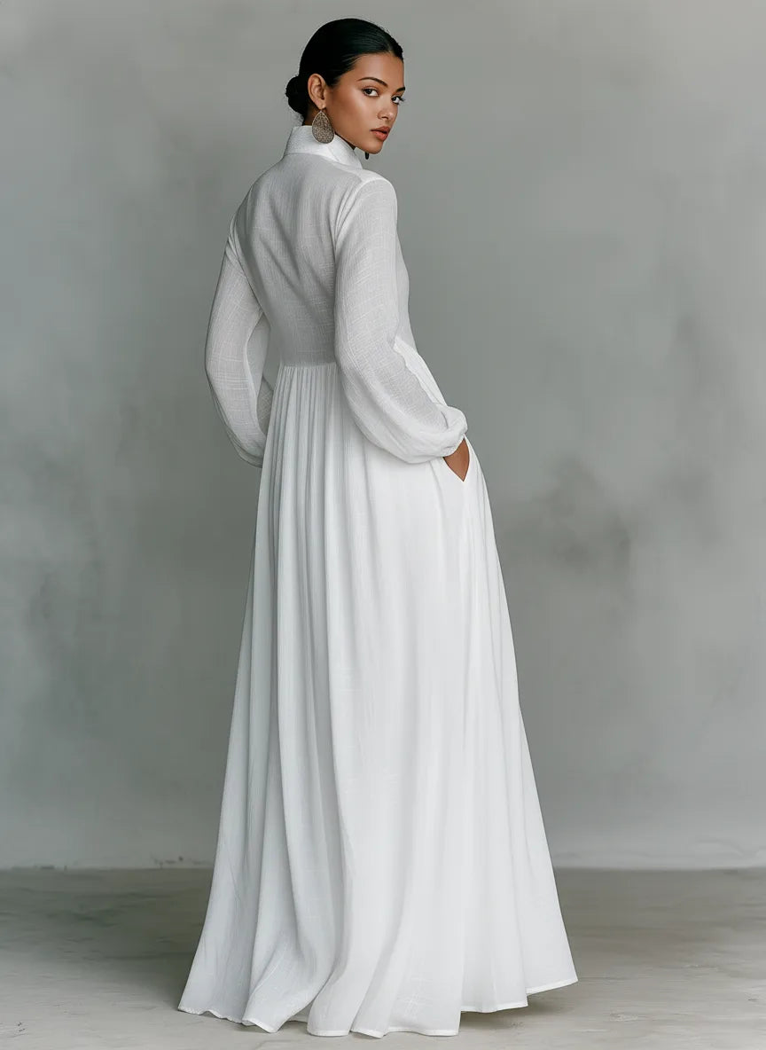 Back view of the white maxi dress showing its relaxed bodice and full gathered skirt with side pocket