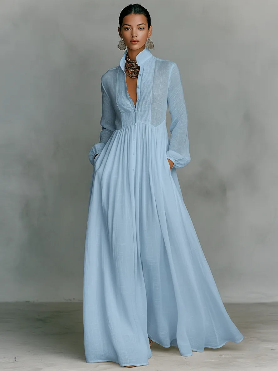 Pale blue version of the maxi shirt dress styled with statement earrings and a flowing skirt