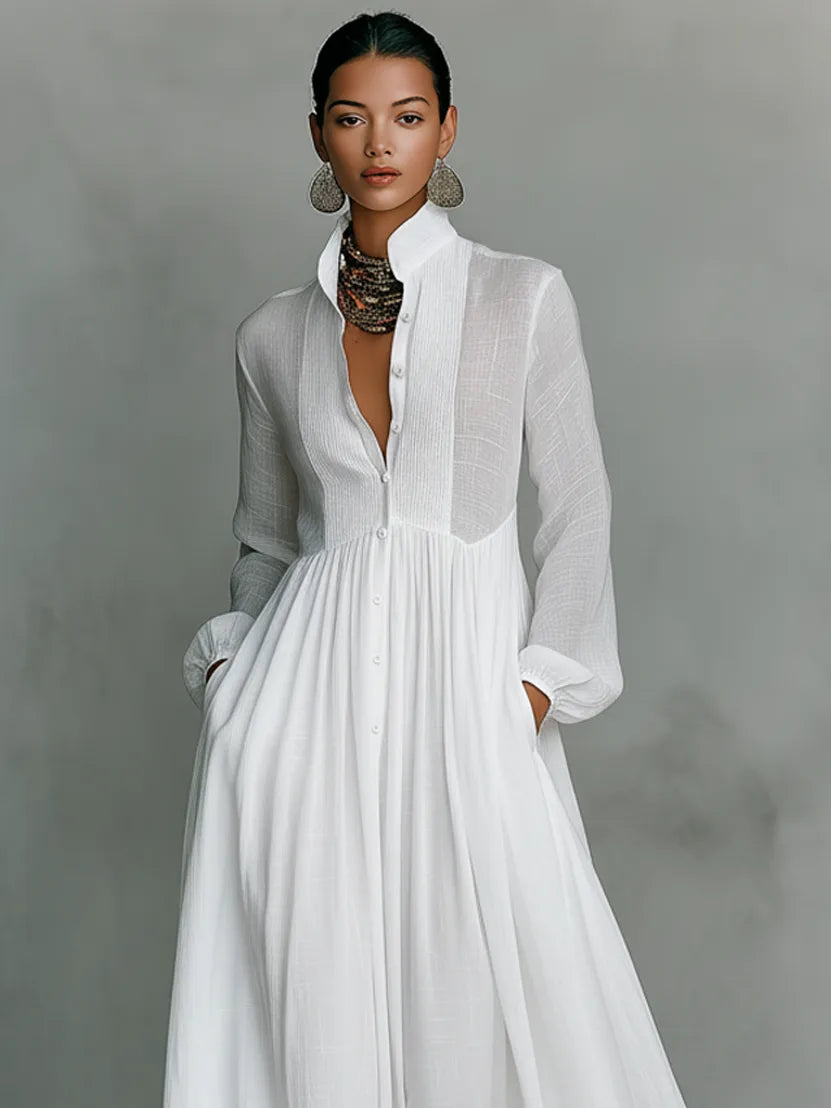 Close-up of the white dress bodice showing the pintuck panel, button placket and high collar