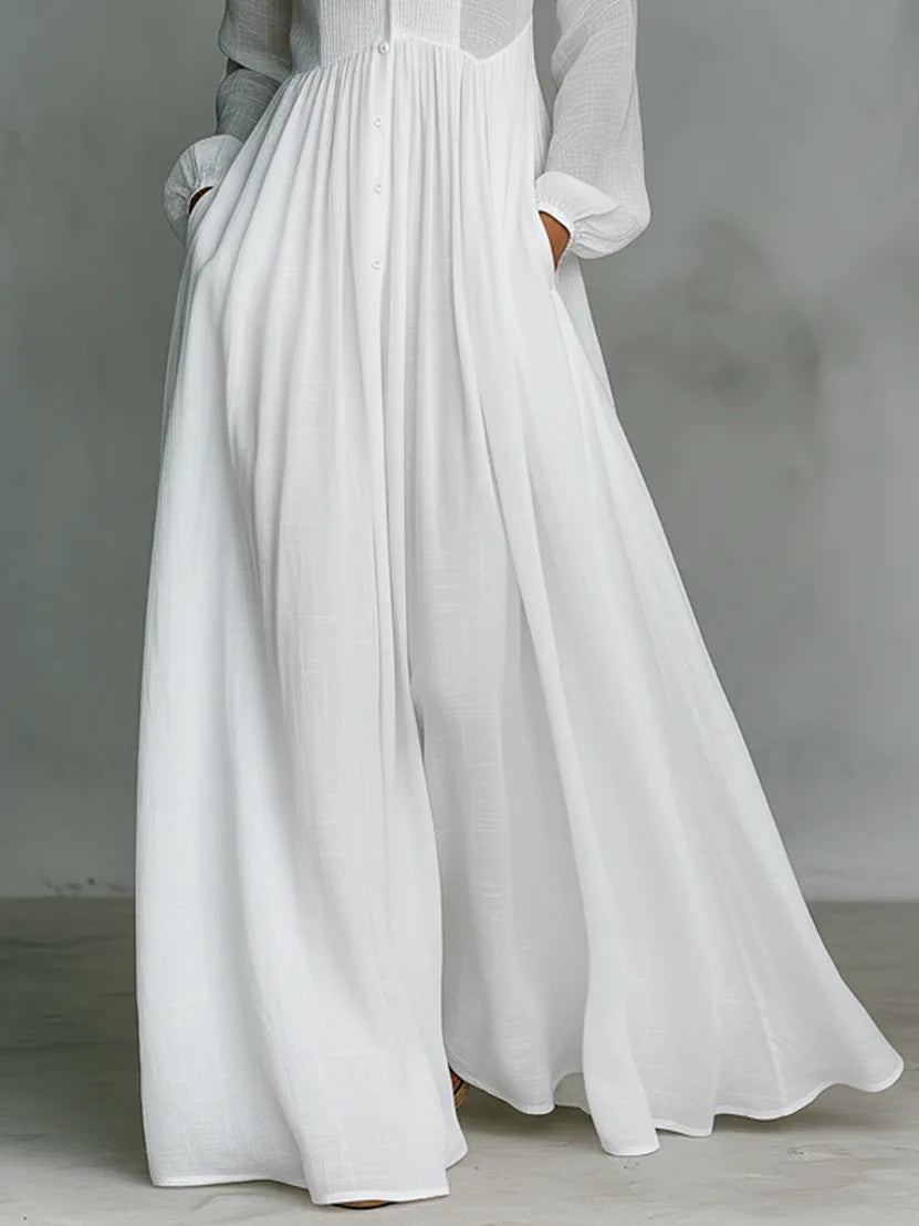 Detail shot of the flowing white skirt fabric and hand resting in the side pocket