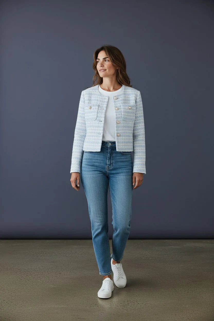 Full-length side view of the cropped tweed-style jacket paired with straight-leg denim and white sneakers.