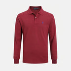 Flat lay detail of the embroidered pony logo on the chest of the polo shirt