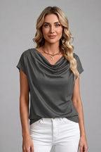 Close-up front view of the dark grey cowl neck top showing the soft draped folds at the neckline