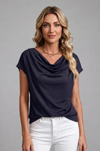 Woman wearing the navy blue cowl neck top with relaxed cap sleeves and a straight hem