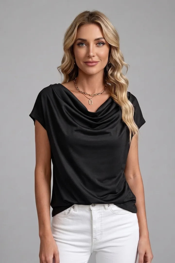 Woman modelling the black cowl neck top with draped front detail and layered gold necklace