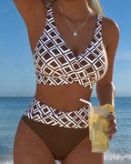 Front view of a wrap-style brown and white geometric print bikini top with high-waisted bottoms worn at the beach