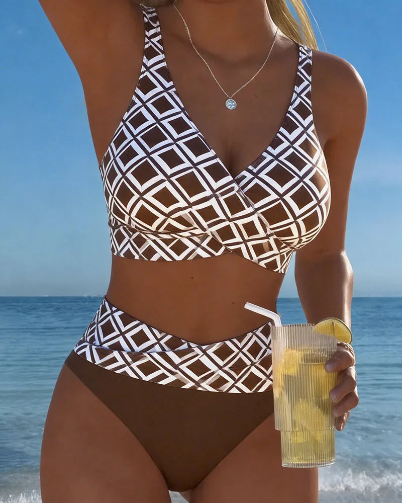 Front view of a wrap-style brown and white geometric print bikini top with high-waisted bottoms worn at the beach