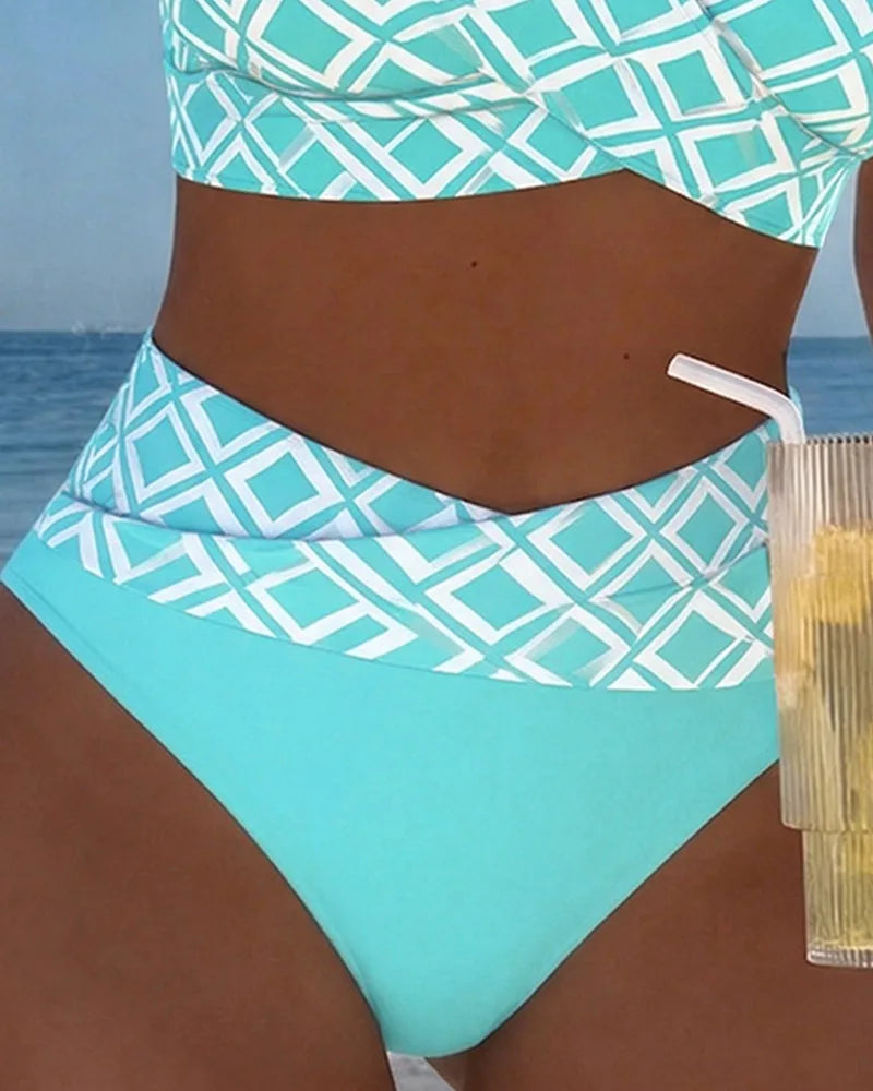 Close-up of the turquoise and white diamond print high-waisted bottom showing the waistband and solid panel detail