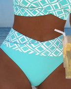 Close-up of the turquoise and white diamond print high-waisted bottom showing the waistband and solid panel detail