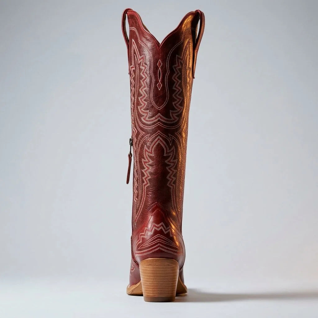Front view of a brown leather cowboy boot showing the pointed toe and intricate stitched pattern