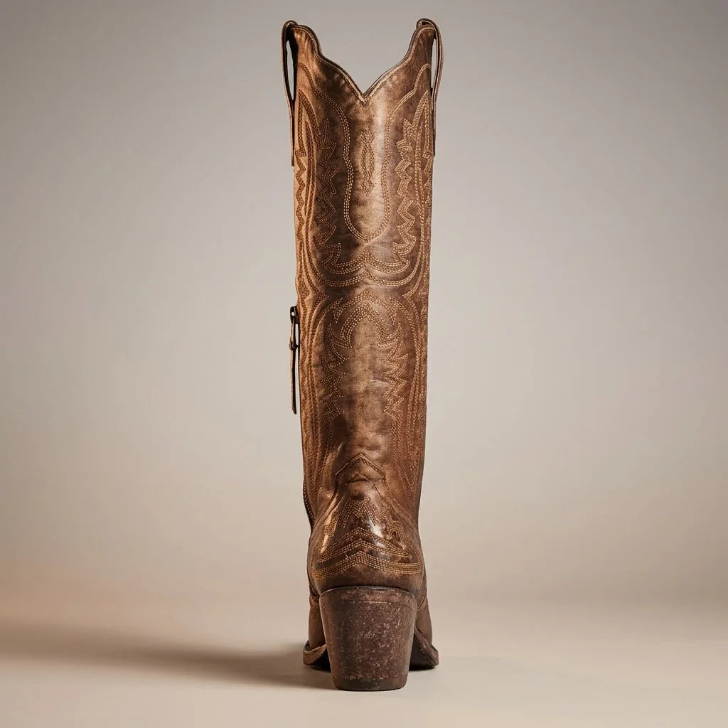 Close-up of the shaft embroidery on a white leather cowboy boot with pull tab detail