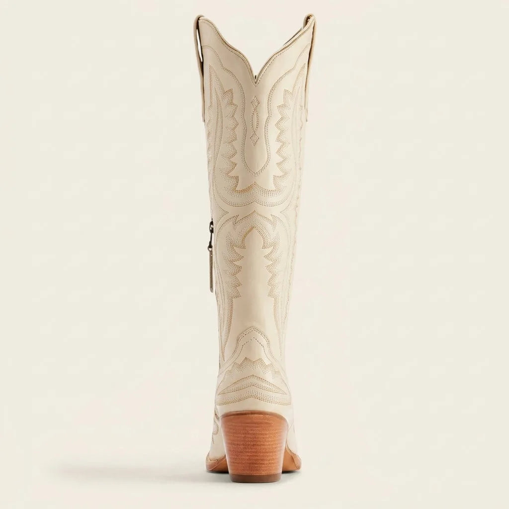 Top view of pink cowboy boots showing the cut-out topline and tan leather lining