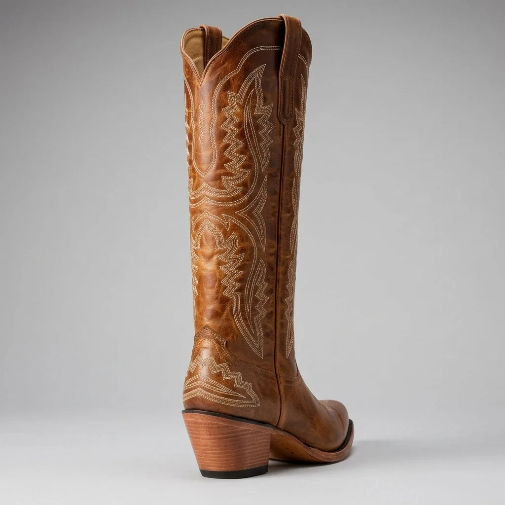Side-by-side view of a pair of brown leather cowboy boots highlighting the curved western heel