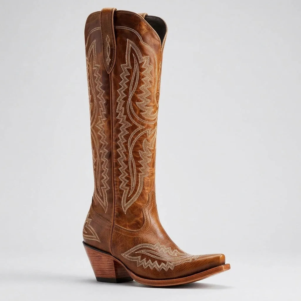 Detail shot of the stacked wooden heel and leather sole on a white cowboy boot