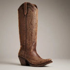 Side profile of a distressed chocolate brown leather cowboy boot with contrast stitching and pointed toe