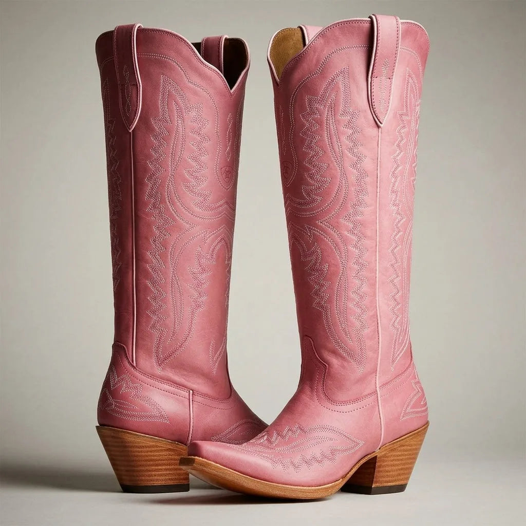 Pair of pink leather knee-high cowboy boots with tonal embroidery, shown standing on a light background