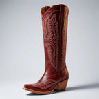 Angled front view of a red leather knee-high cowboy boot showing the pointed toe and pull tab