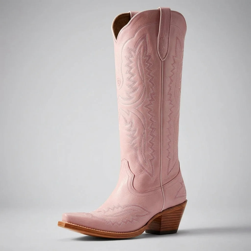 Front angled view of a pink leather cowboy boot highlighting the snip toe and stacked wooden heel
