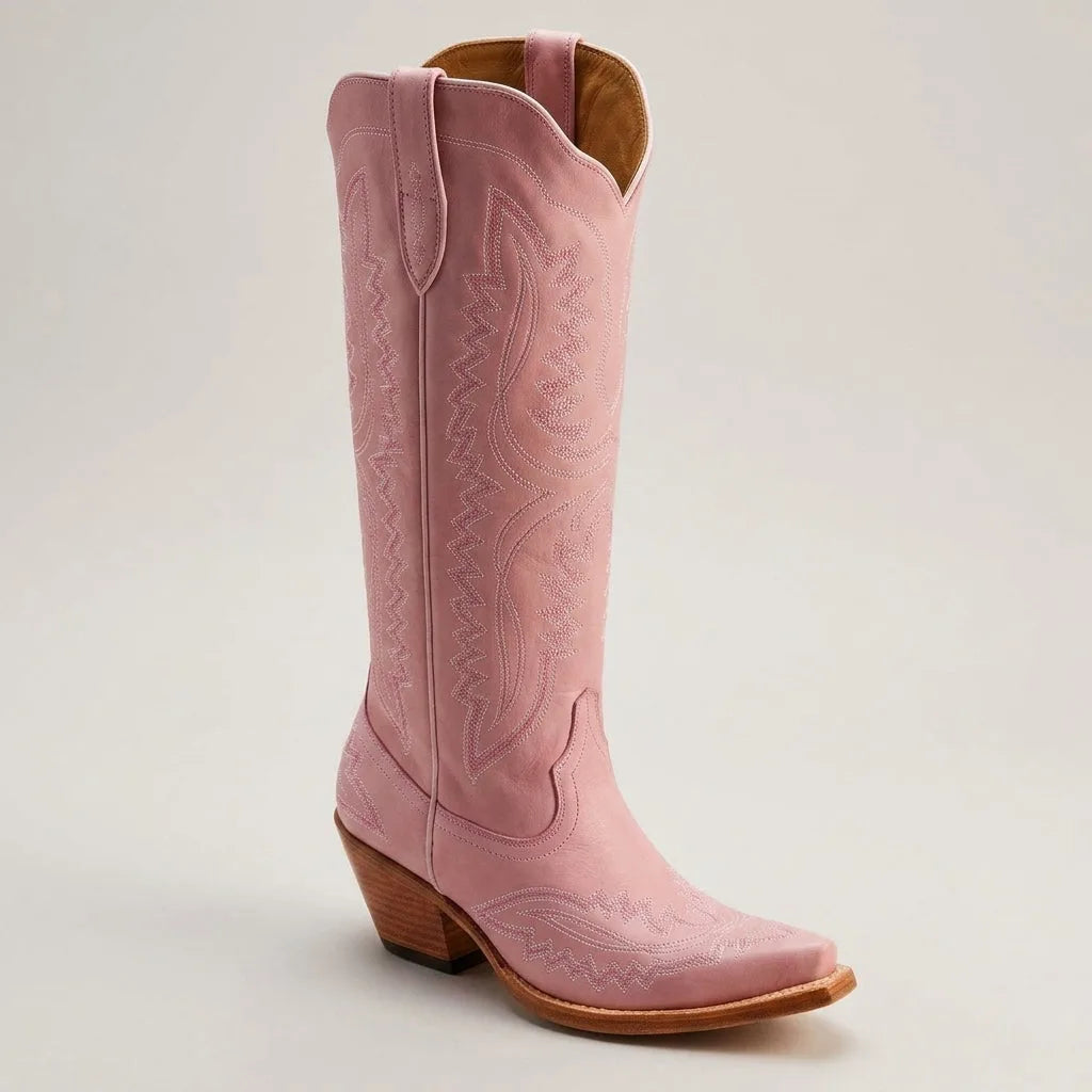 Close side view of a pink nubuck leather cowboy boot showing soft matte texture and tonal stitching