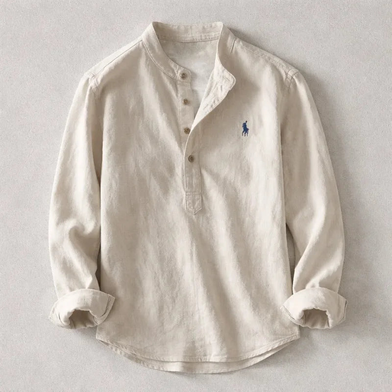 Oatmeal beige henley shirt with band collar and embroidered logo, long sleeves rolled up, laid flat