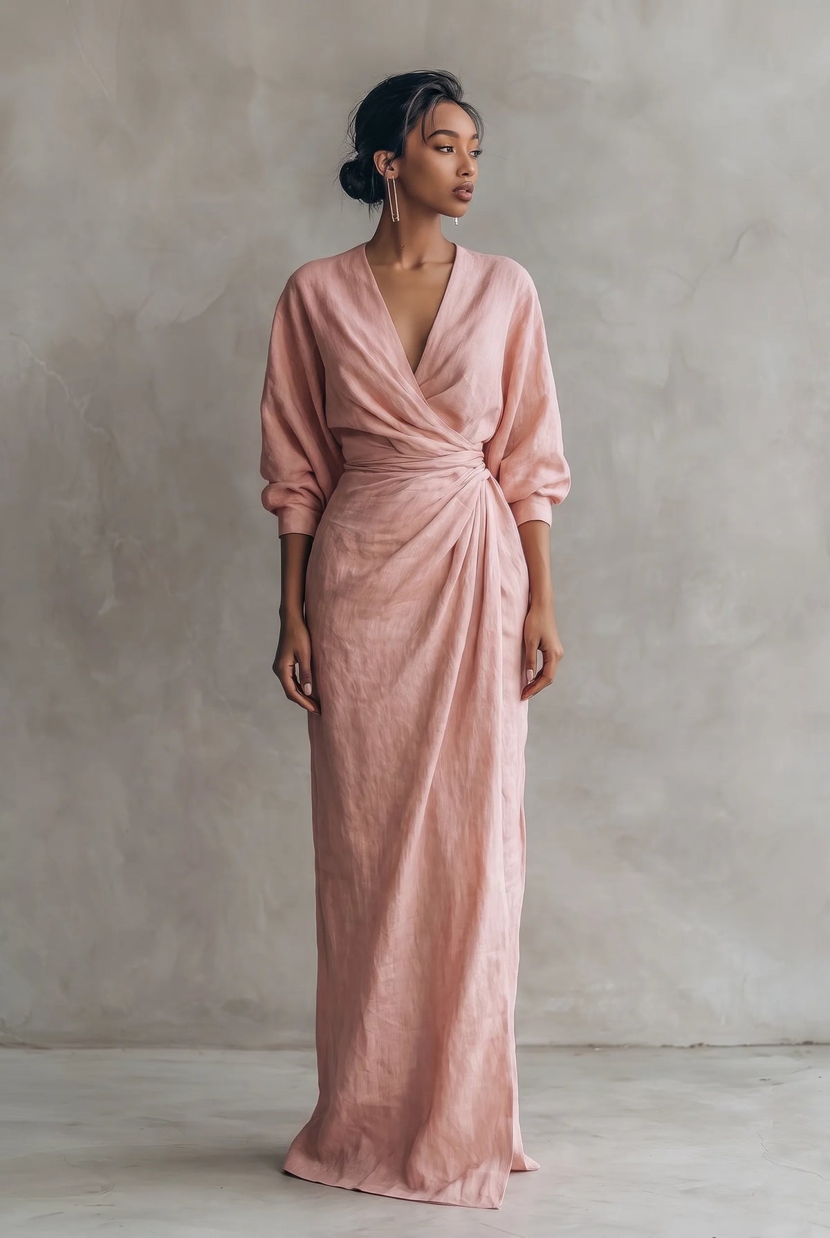 Front view of a model wearing a dusty pink linen-blend maxi dress with draped wrap-style V-neckline and full sleeves